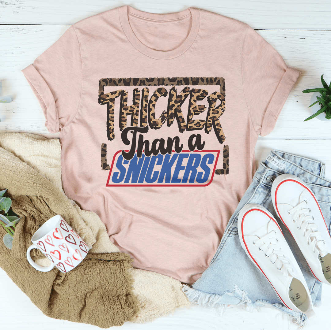 Thicker Than A Snickers T-Shirt displayed on a mannequin, showcasing its soft cotton fabric and double-stitched neckline.