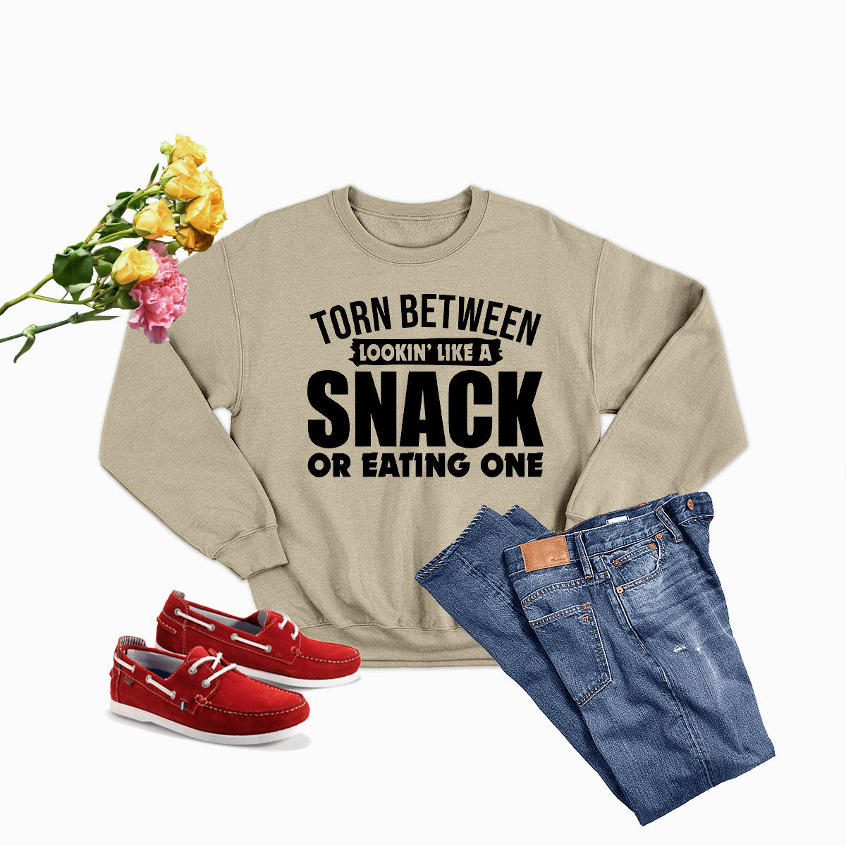 A cozy sweatshirt featuring the phrase 'Torn Between Lookin Like A Snack Or Eating One', made from soft ring-spun cotton with double stitching.