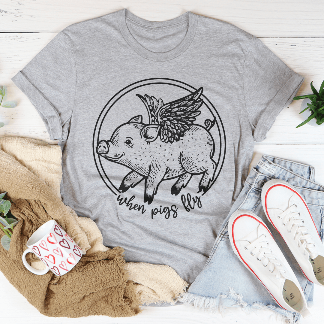 A comfortable When Pigs Fly Tee made of soft ring-spun cotton, featuring double stitching for durability, available in various colors.