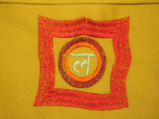 OMSutra Chakra Yoga Kit Bag in vibrant orange with chakra embroidery, designed to hold yoga essentials.