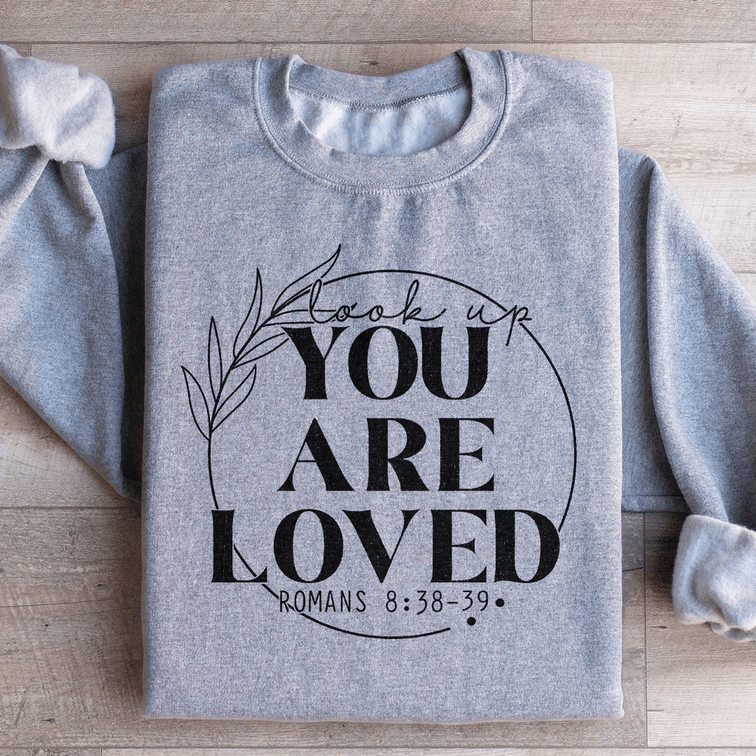 Cozy 'You Are Loved' sweats featuring a cotton/poly fleece blend, designed by top artists for ultimate comfort and style.