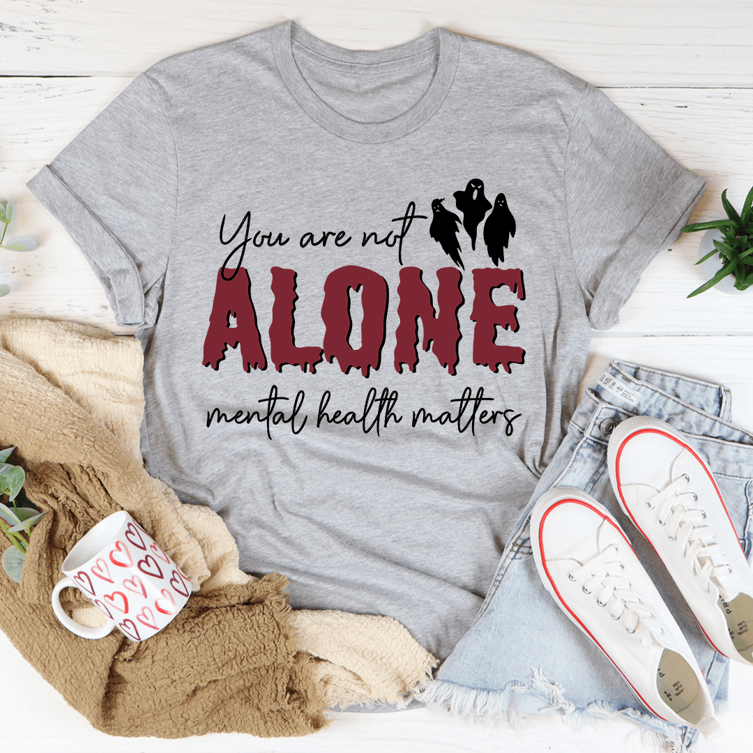 You Are Not Alone Mental Health Awareness Halloween Tee featuring a vibrant design on a soft cotton fabric.