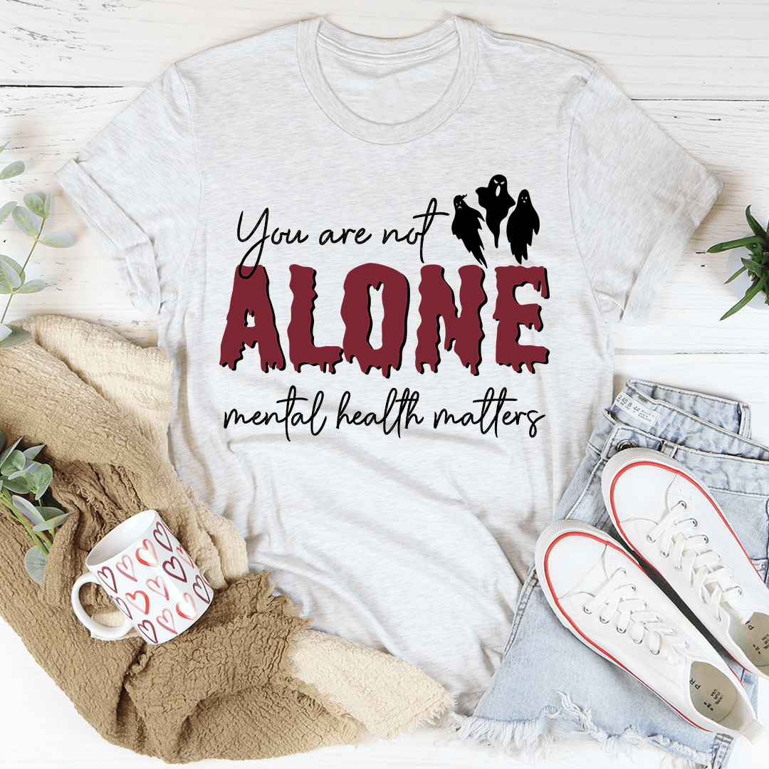 You Are Not Alone Mental Health Awareness Halloween Tee featuring a vibrant design on a soft cotton fabric.