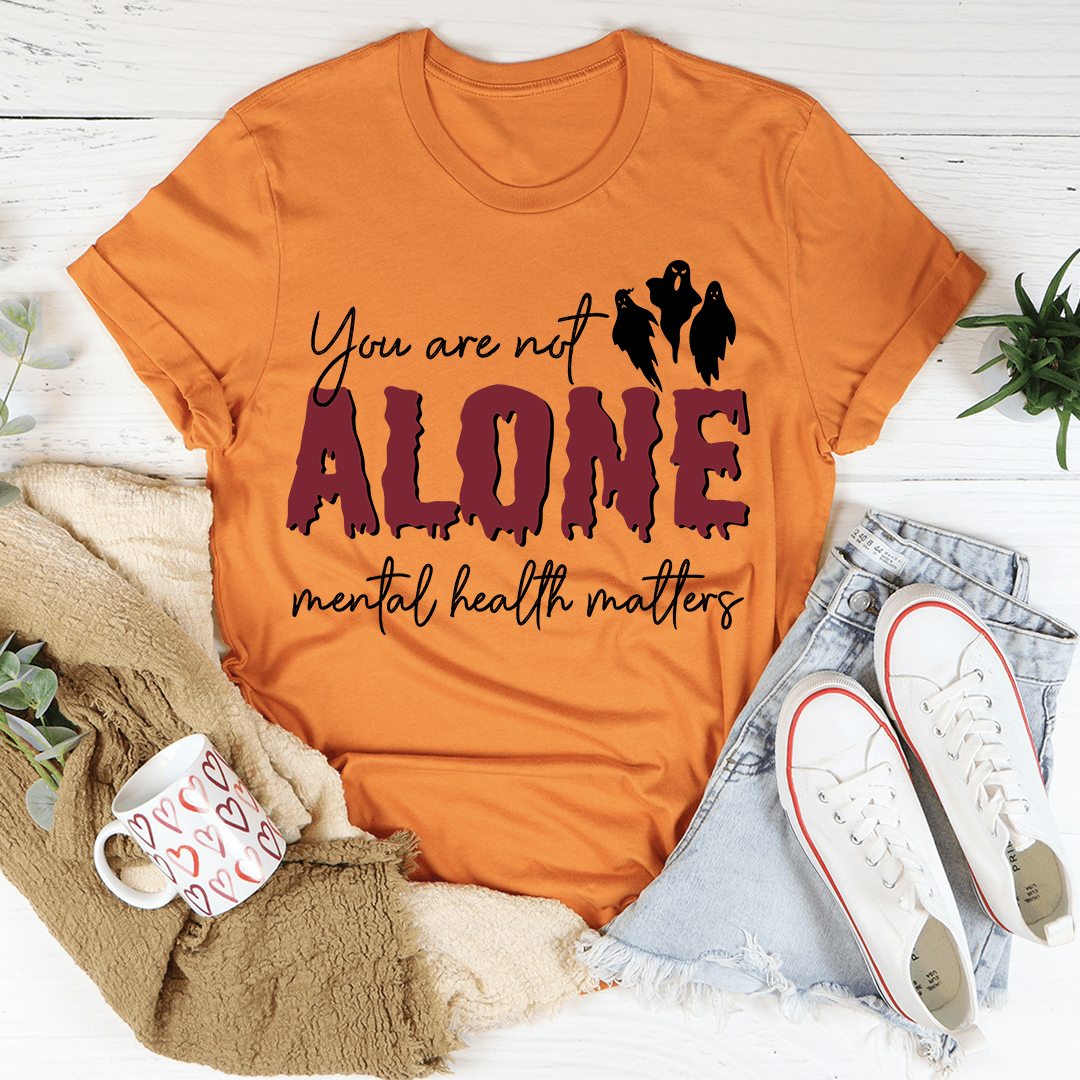 You Are Not Alone Mental Health Awareness Halloween Tee featuring a vibrant design on a soft cotton fabric.