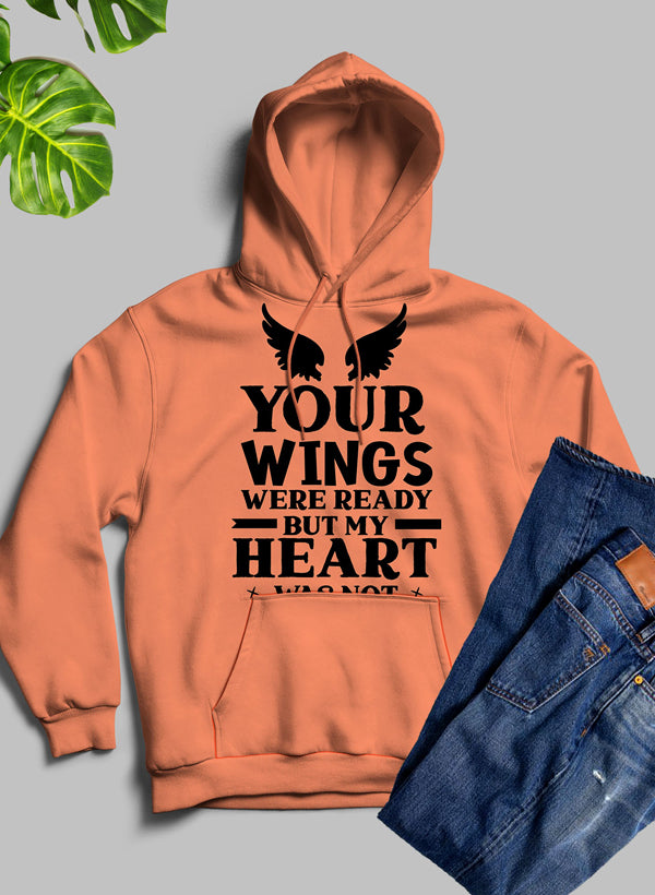 A cozy 'Your Wings Were Ready But...' hoodie featuring a unique artistic design, adjustable hood, and banded cuffs for warmth.