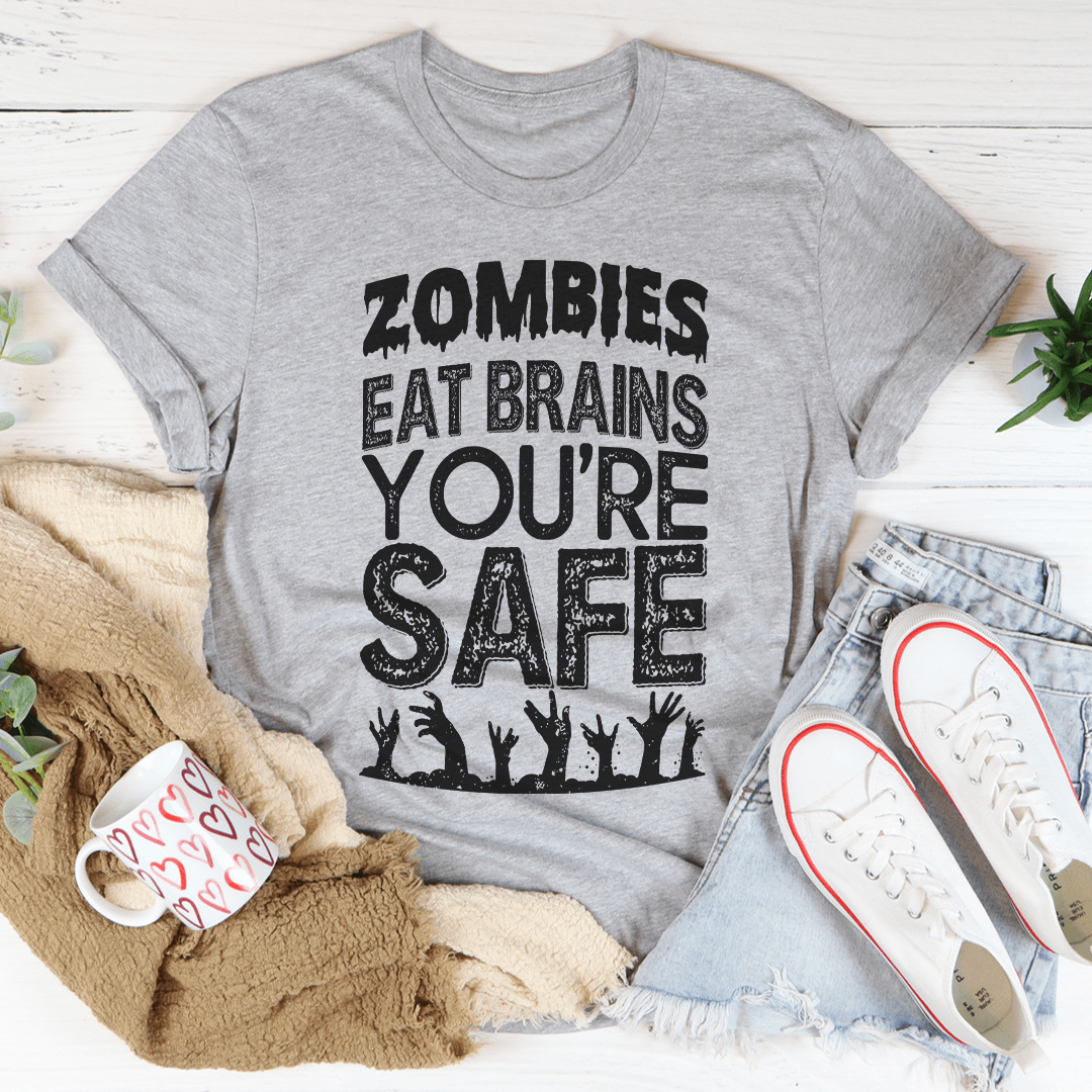 Zombies Eat Brains You're Safe T-Shirt displayed on a mannequin, featuring a humorous zombie-themed graphic.