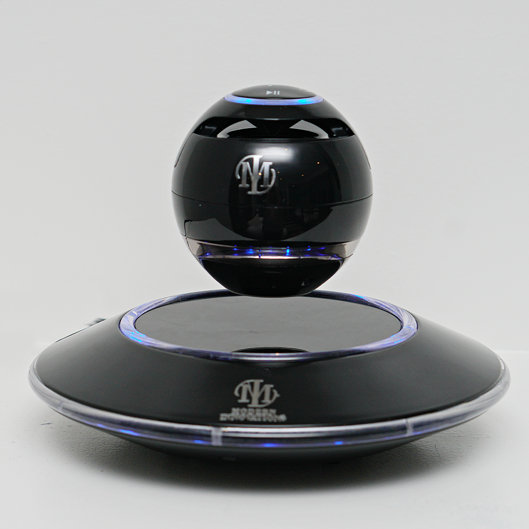 Levitating Bluetooth Speakers in black and white design, floating above a sleek magnetic base, showcasing modern technology and style.