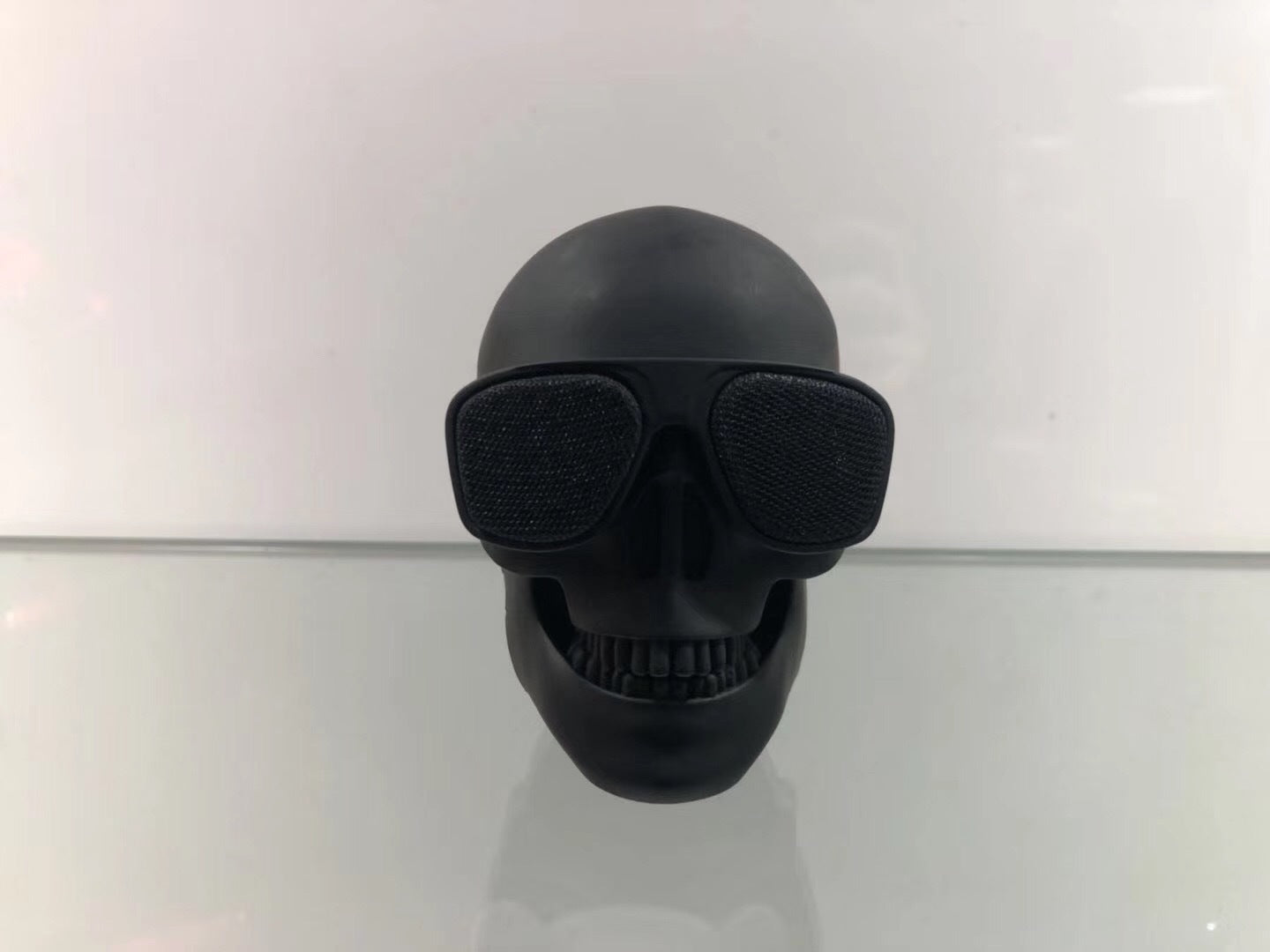 Wireless Bluetooth Speaker in the shape of a cartoon bone ghost head, featuring a playful design and compact size.