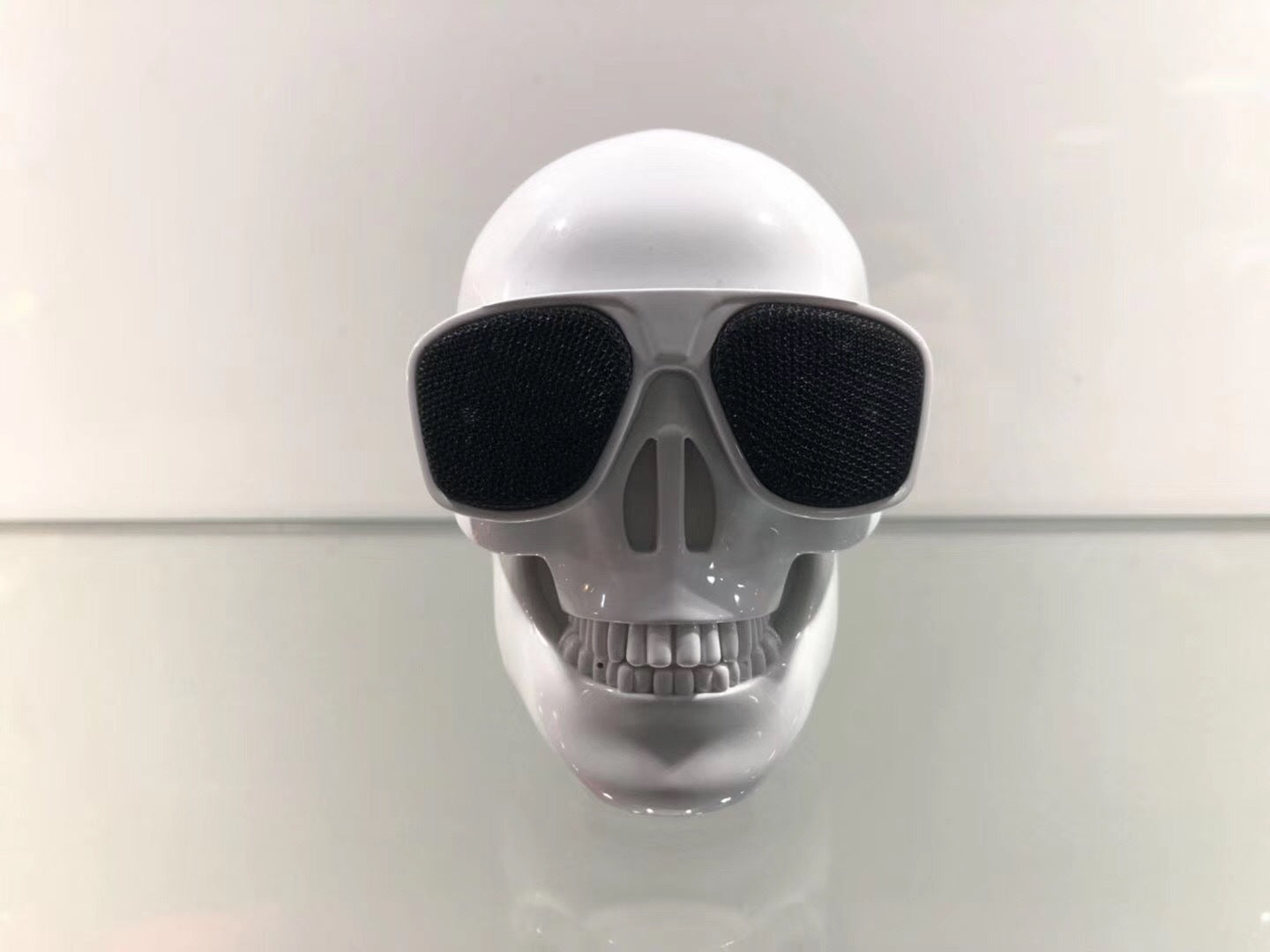 Wireless Bluetooth Speaker in the shape of a cartoon bone ghost head, featuring a playful design and compact size.