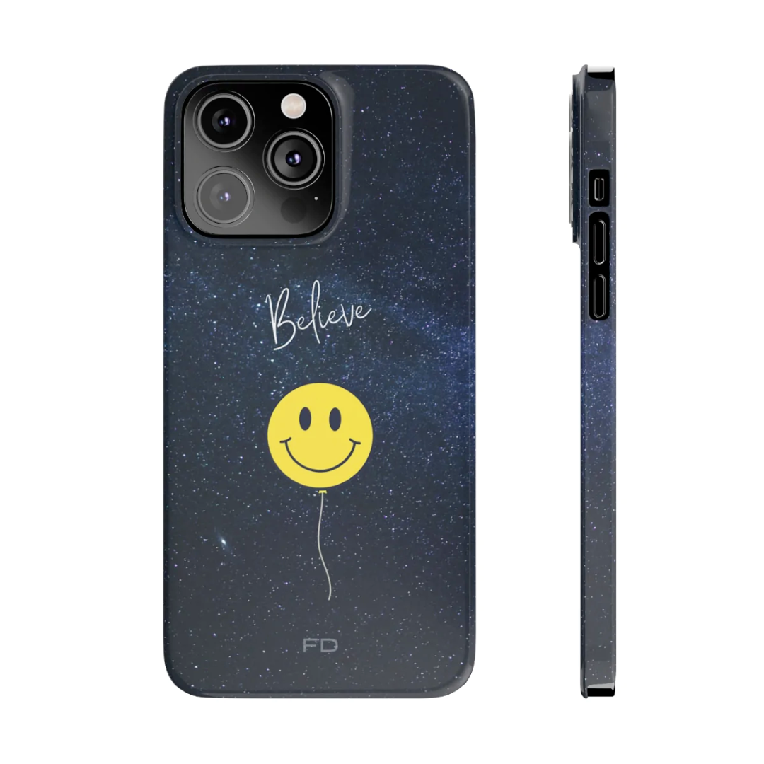 Smiley Face in Space Believe Slim Case for iPhone 14, featuring a glossy finish and a fun cosmic design.