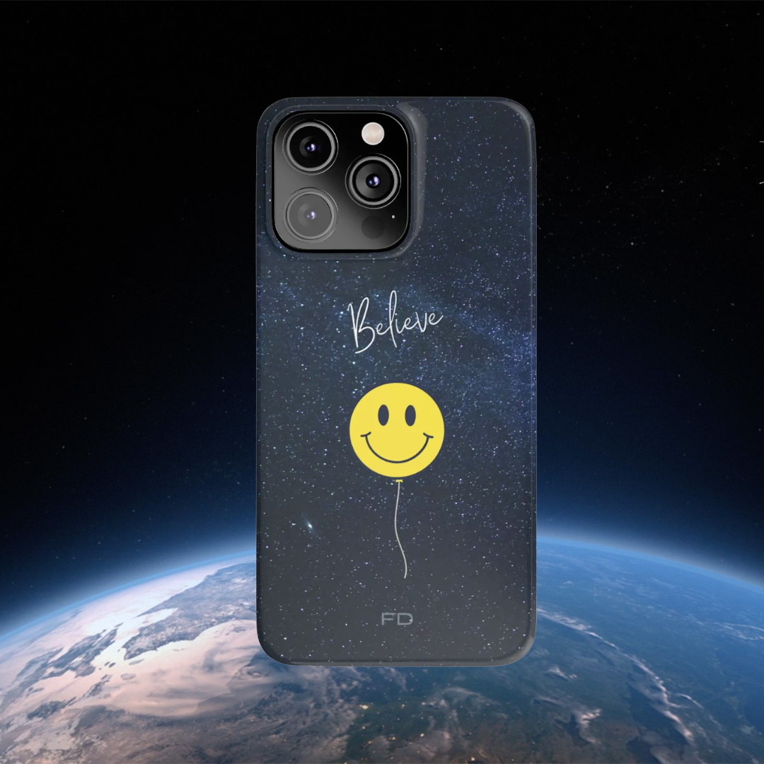 Smiley Face in Space Believe Slim Case for iPhone 14, featuring a glossy finish and a fun cosmic design.