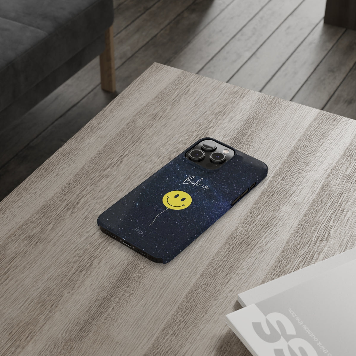 Smiley Face in Space Believe Slim Case for iPhone 14, featuring a glossy finish and a fun cosmic design.