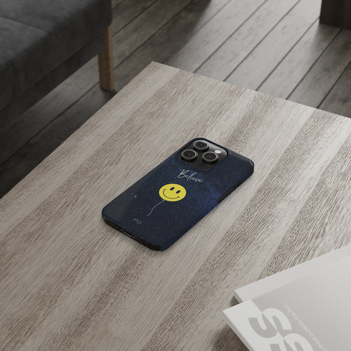 Smiley Face in Space Believe Slim Case for iPhone 14, featuring a glossy finish and a fun cosmic design.