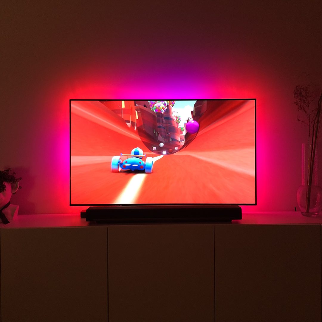 LED TV Mood Light with colorful LED strip illuminating a TV, showcasing vibrant colors and remote control.