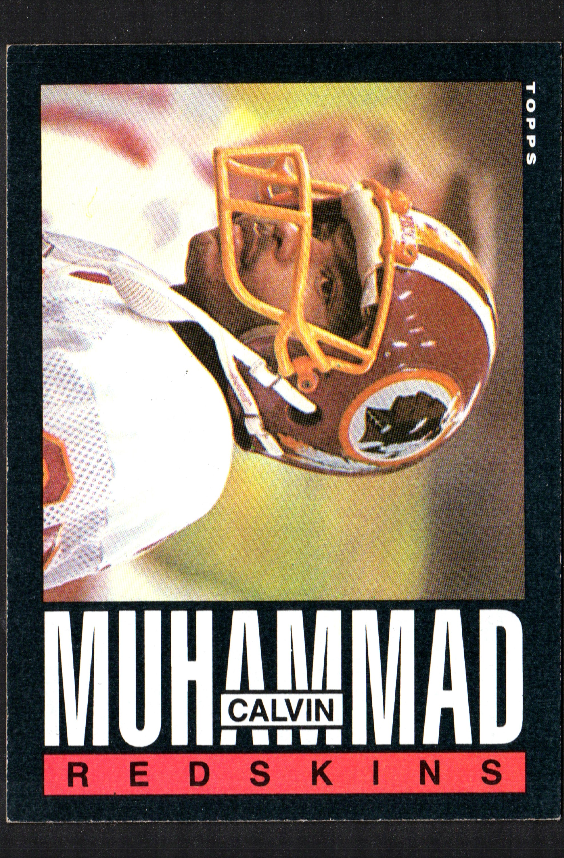 1985 Topps trading card featuring Calvin Muhammad of the Washington Redskins, showcasing vibrant colors and detailed player information.