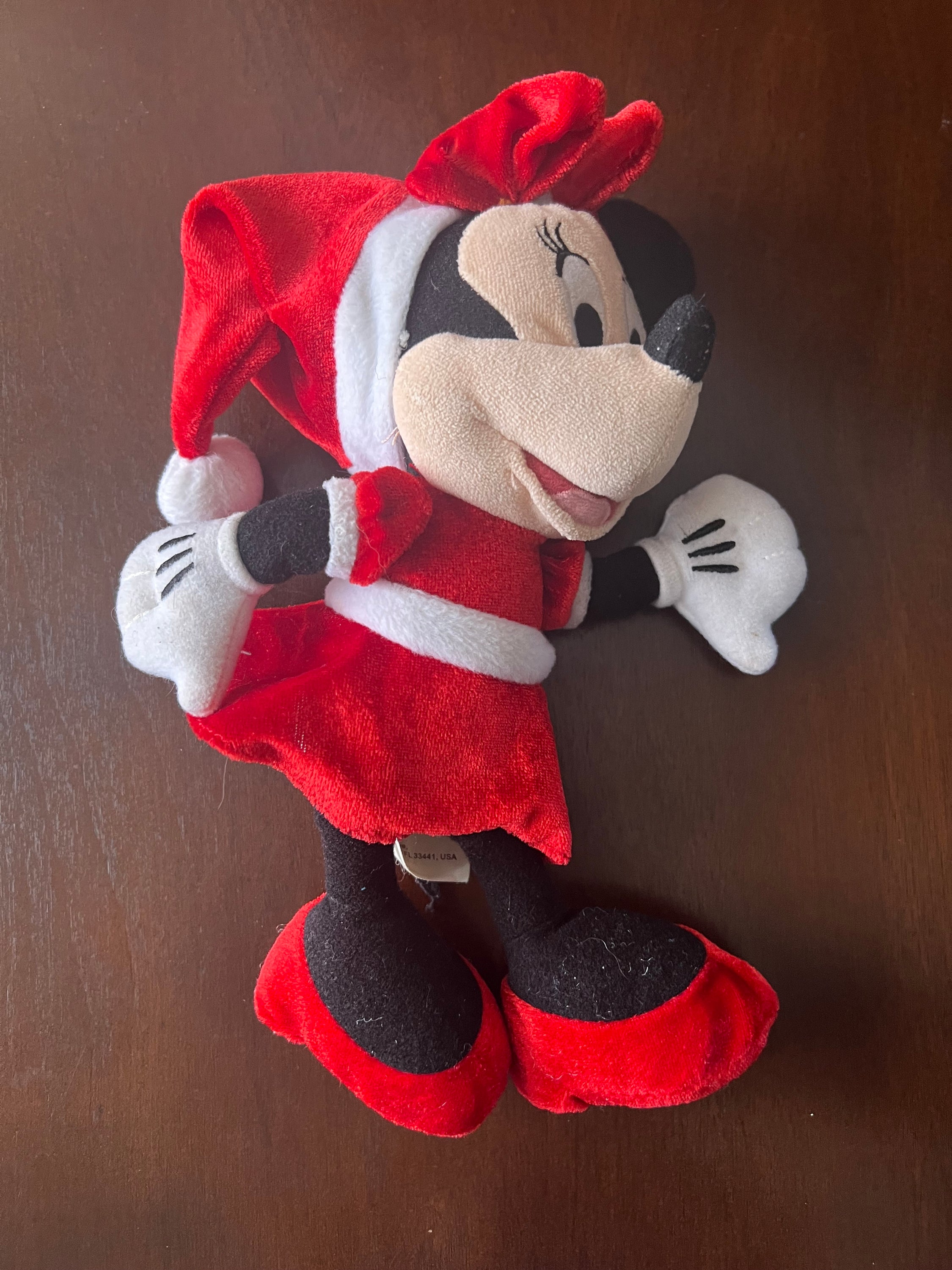 Disney Minnie Mouse plush toy wearing a festive Santa hat and red velvet dress, perfect for holiday celebrations.