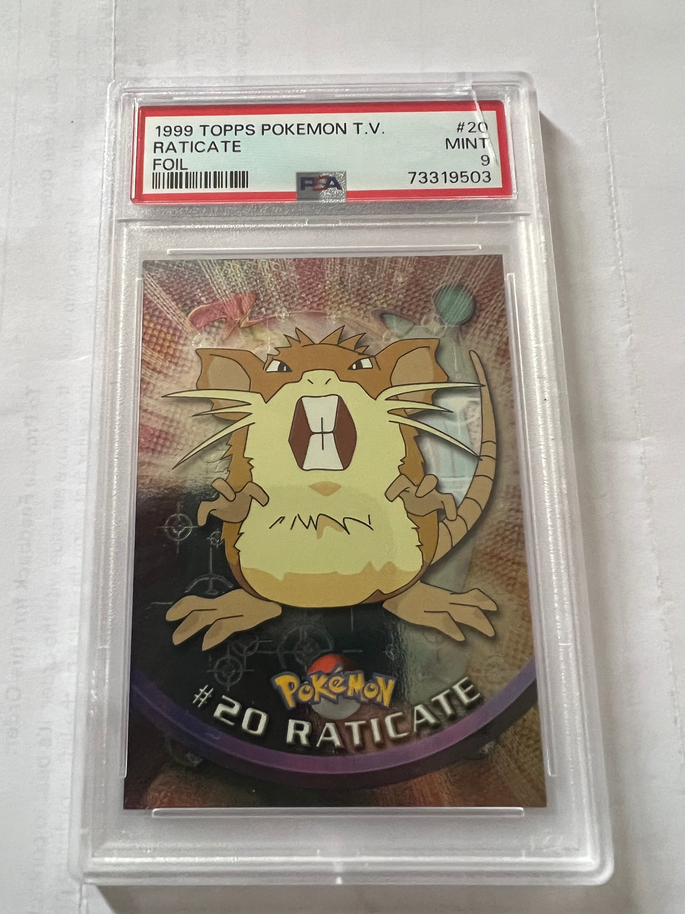 Raticate Pokémon TCG card from 1990 Topps series, featuring black logo and foil finish, in PSA 9 condition.