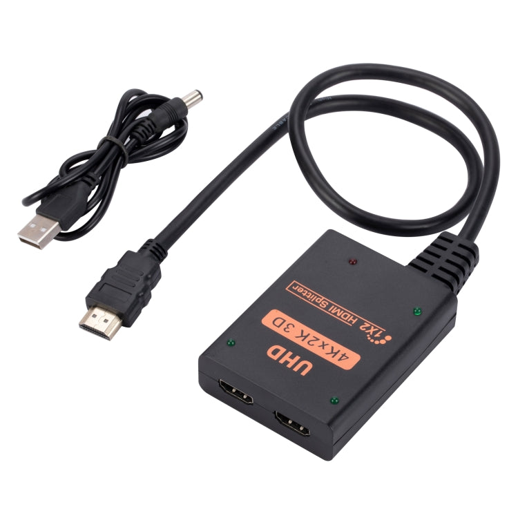 1 into 2 out HDMI 4K HD Video Splitter with power supply cord, showcasing its compact design and ports.