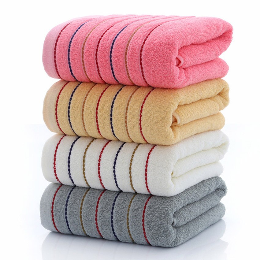 A set of luxurious 100% cotton striped towels in vibrant colors, showcasing their soft texture and stylish design.