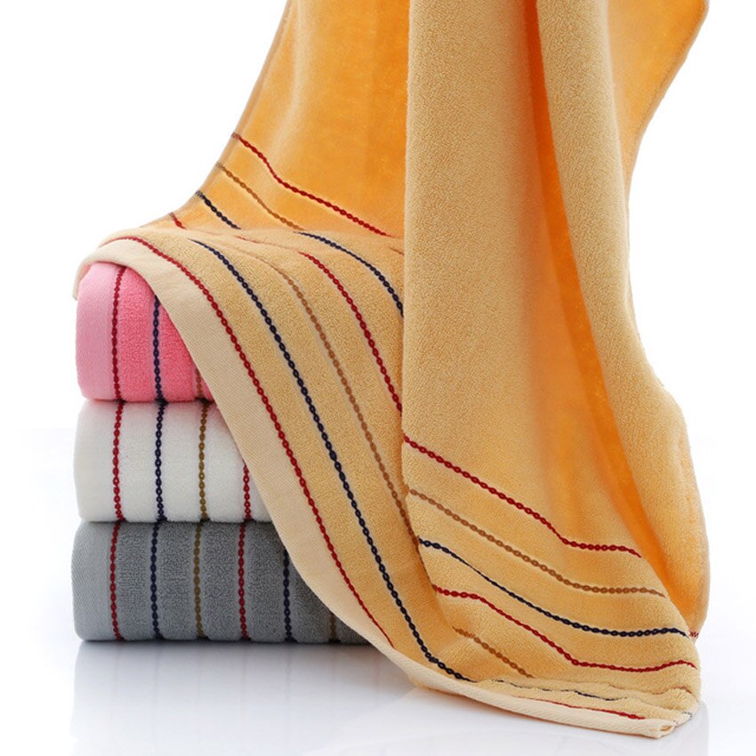 A set of luxurious 100% cotton striped towels in vibrant colors, showcasing their soft texture and stylish design.