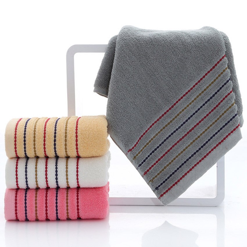 A set of luxurious 100% cotton striped towels in vibrant colors, showcasing their soft texture and stylish design.