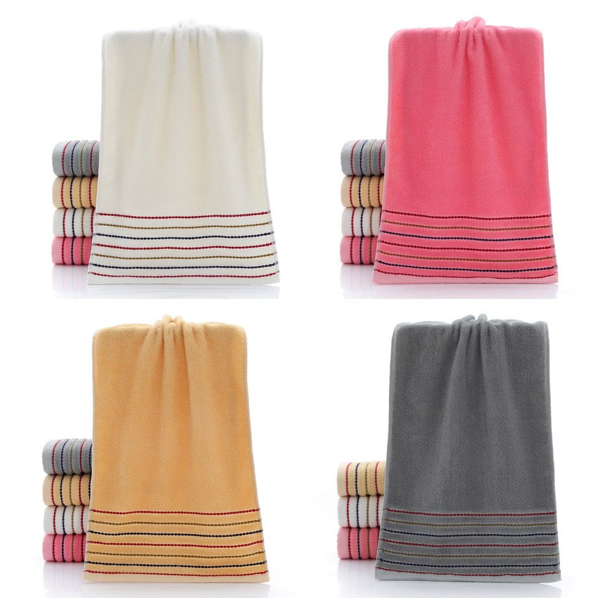 A set of luxurious 100% cotton striped towels in vibrant colors, showcasing their soft texture and stylish design.