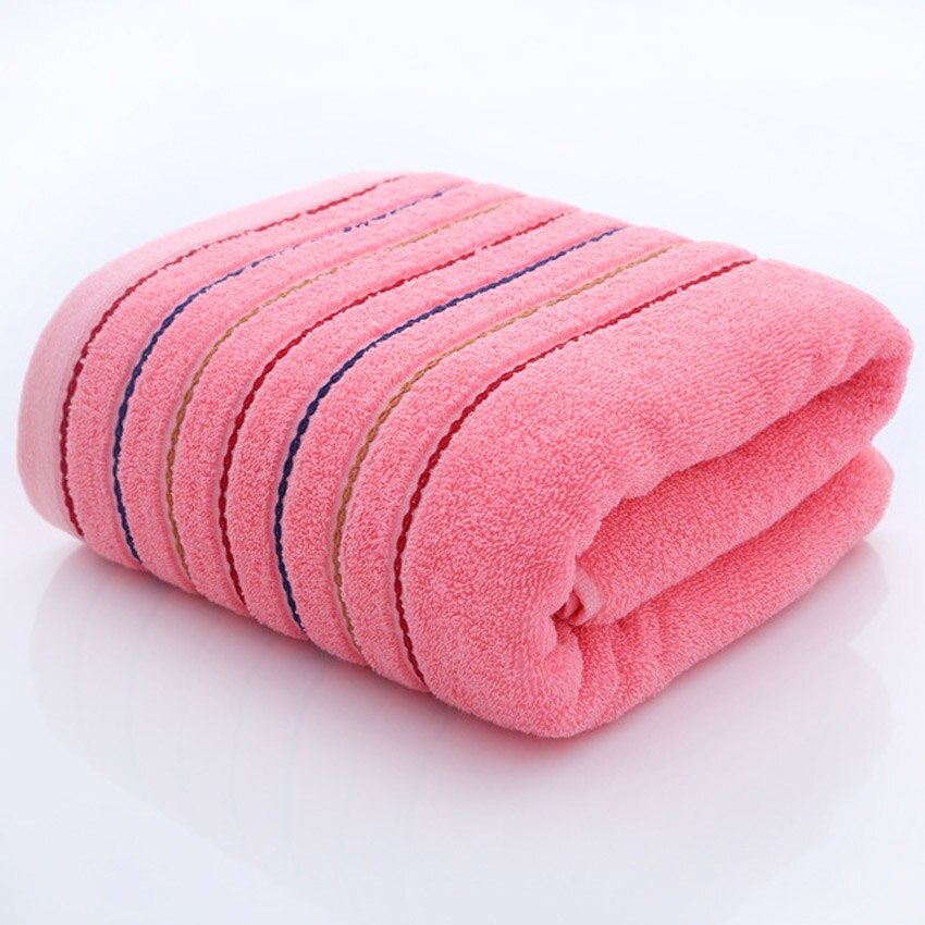 A set of luxurious 100% cotton striped towels in vibrant colors, showcasing their soft texture and stylish design.