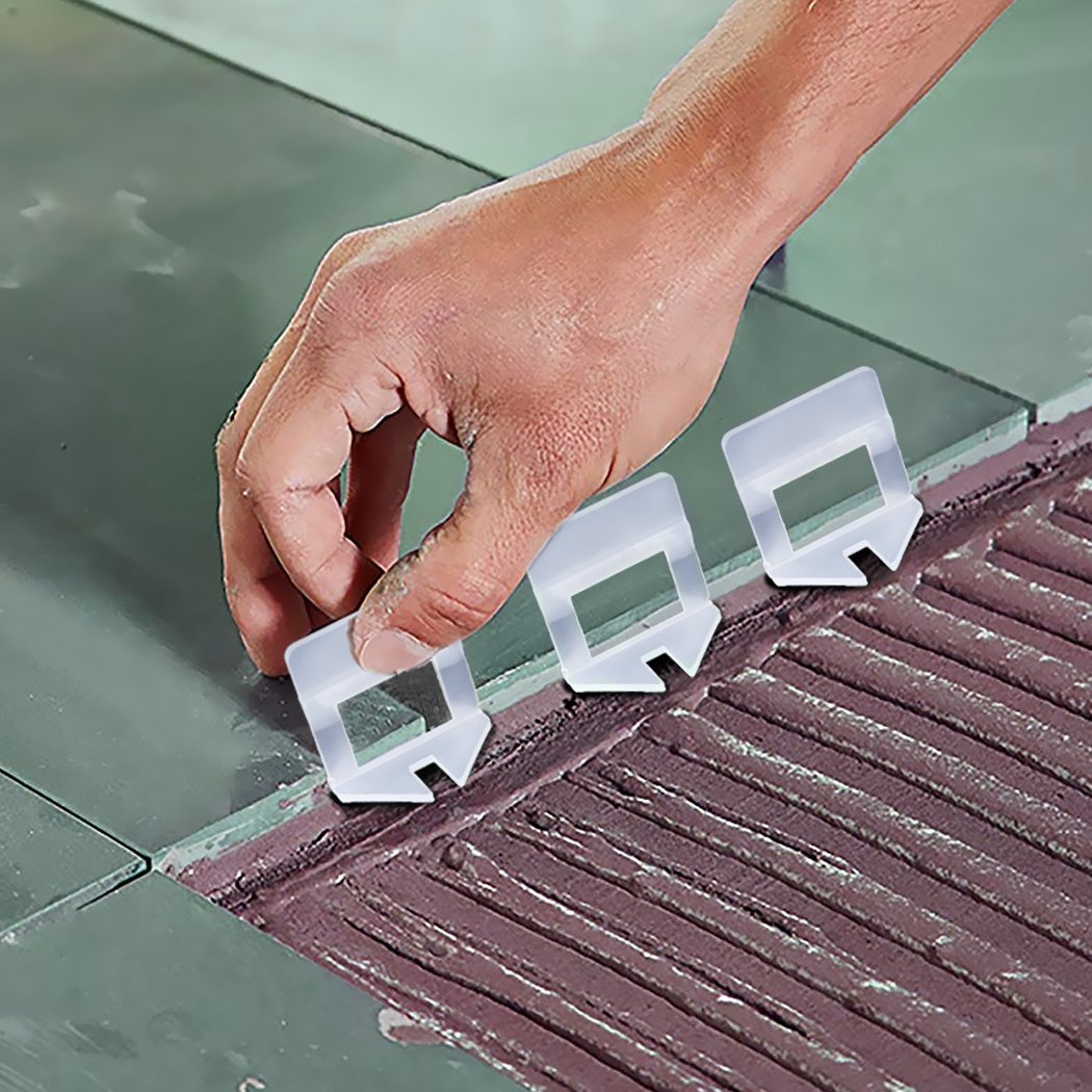 A pack of 1000 1MM Tile Leveling System Clips, showcasing white plastic clips designed for precise tile alignment during installation.