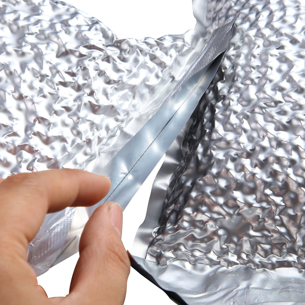 100x Commercial Grade Vacuum Sealer Bags in silver, showcasing their thickness and quality for food storage.