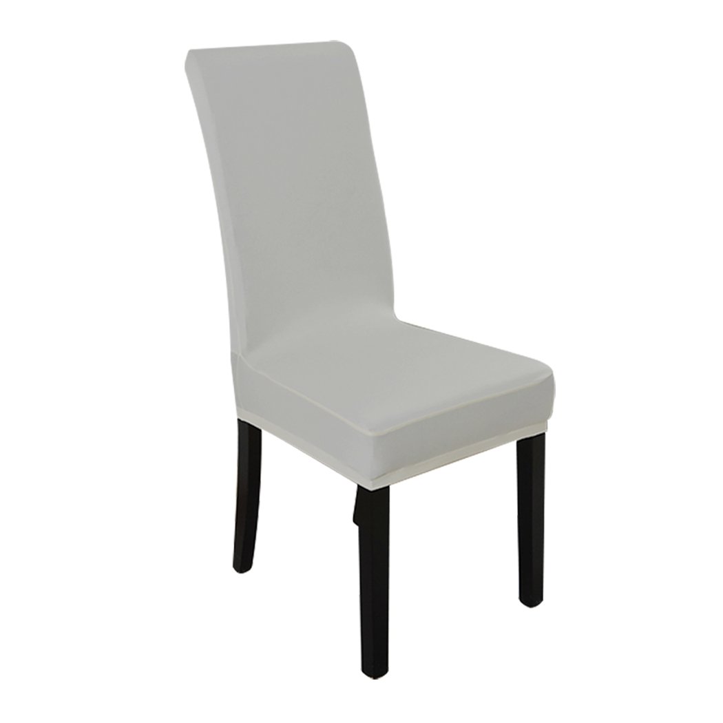 A set of elegant stretch elastic chair covers in a dining room setting, showcasing their soft fabric and secure fit.