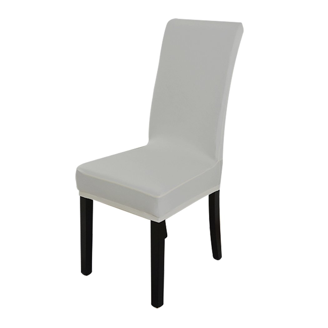 A set of elegant stretch elastic chair covers in a dining room setting, showcasing their soft fabric and secure fit.