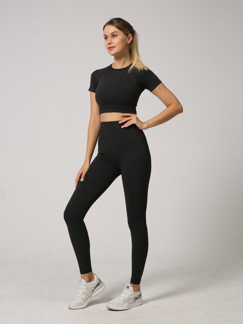 A stylish 2 PCS Seamless Yoga Set for women, featuring a short sleeve crop top and high waist leggings in vibrant colors.