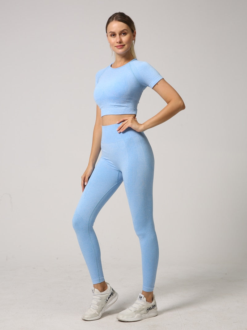 A stylish 2 PCS Seamless Yoga Set for women, featuring a short sleeve crop top and high waist leggings in vibrant colors.