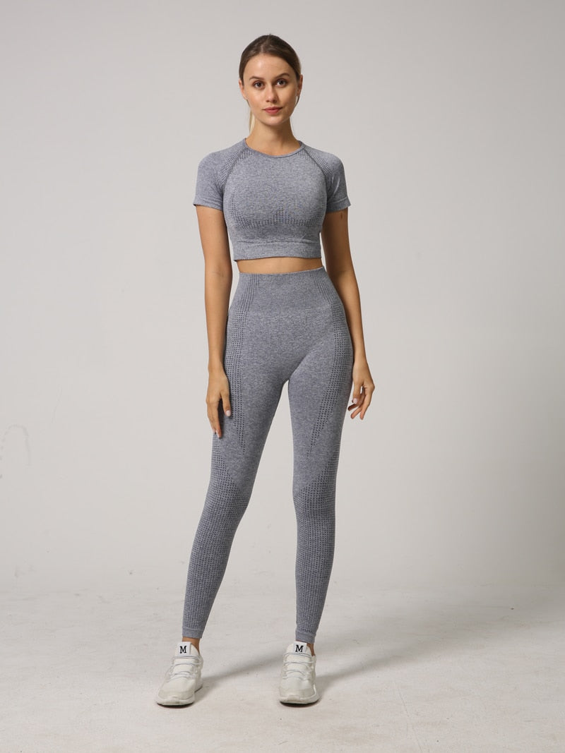 A stylish 2 PCS Seamless Yoga Set for women, featuring a short sleeve crop top and high waist leggings in vibrant colors.