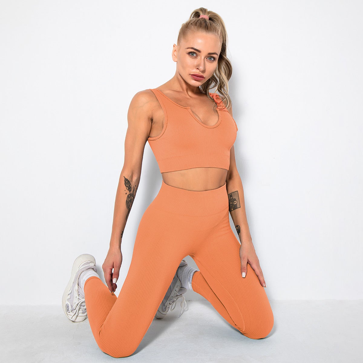 A stylish 2 pieces seamless yoga set for women, featuring high waist leggings and a matching sports bra in various colors.