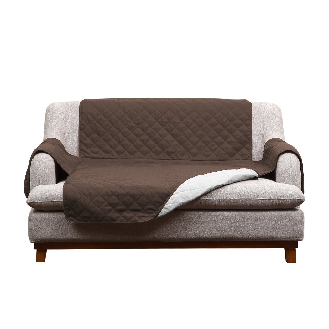 A cozy 2 seater couch covered with a removable quilted sofa cover in coffee color, showcasing its plush microfiber filling and anti-slip base.