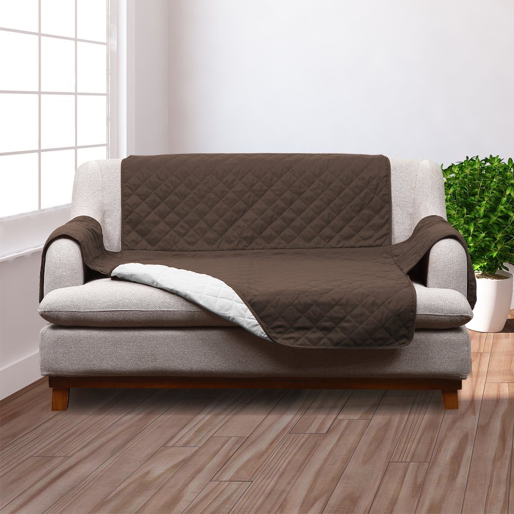 A cozy 2 seater couch covered with a removable quilted sofa cover in coffee color, showcasing its plush microfiber filling and anti-slip base.