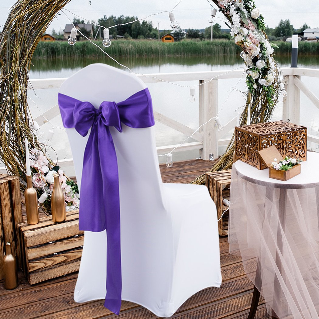 20 satin chair sashes in various colors elegantly draped over chairs, showcasing their luxurious fabric and versatility for event decoration.