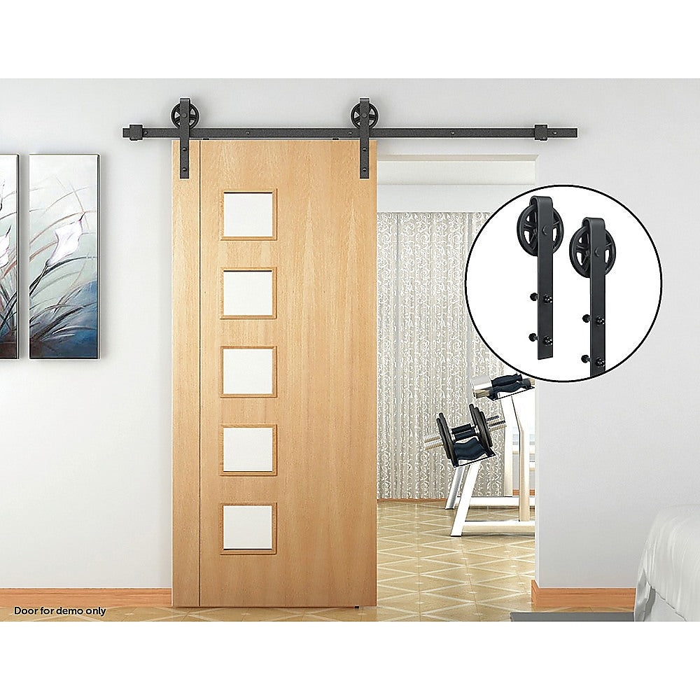 2M Big Spoke Wheel Sliding Barn Door Hardware set featuring a stylish black finish and robust carbon steel construction.