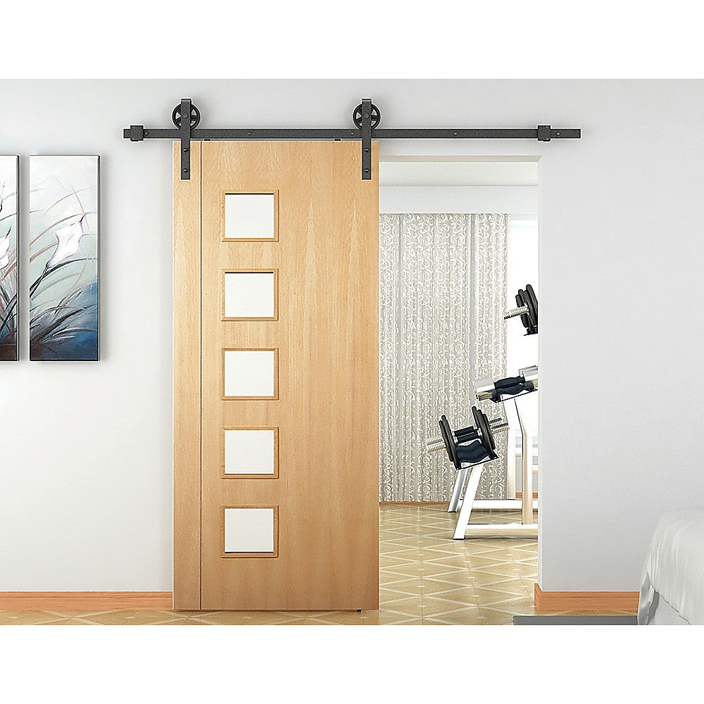 2M Big Spoke Wheel Sliding Barn Door Hardware set featuring a stylish black finish and robust carbon steel construction.