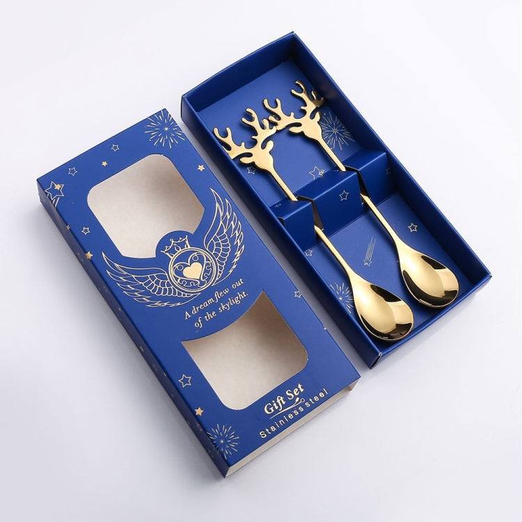 Two Christmas-themed stainless steel stirring spoons with deer design, perfect for holiday beverages.