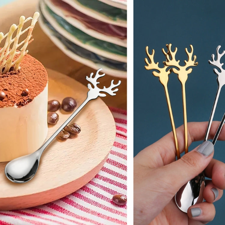 Two Christmas-themed stainless steel stirring spoons with deer design, perfect for holiday beverages.