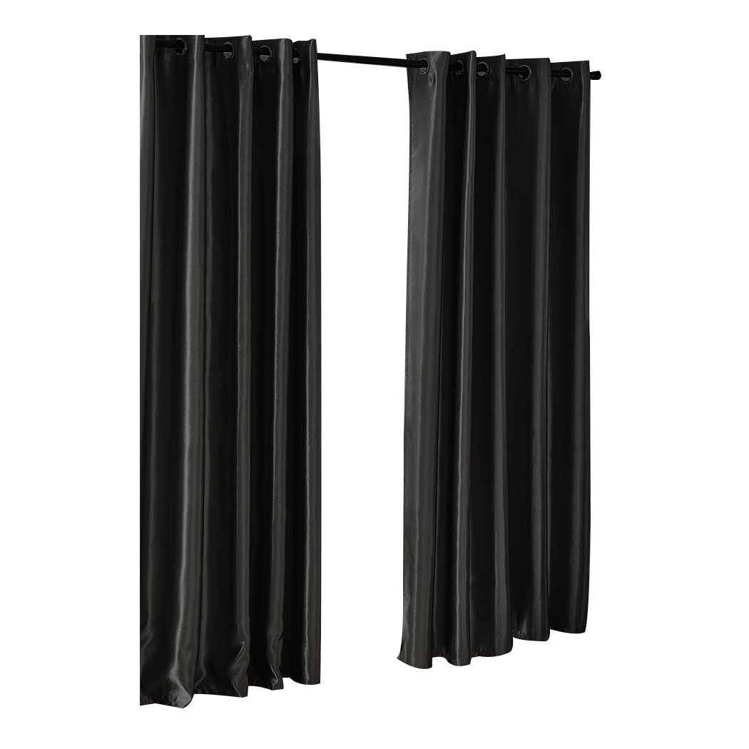 Elegant black 2X blockout curtains with eyelet design, perfect for bedroom windows, providing light blocking and noise reduction.