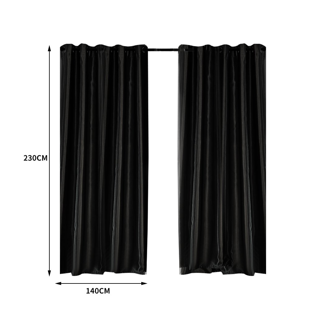 Elegant black 2X blockout curtains with eyelet design, perfect for bedroom windows, providing light blocking and noise reduction.