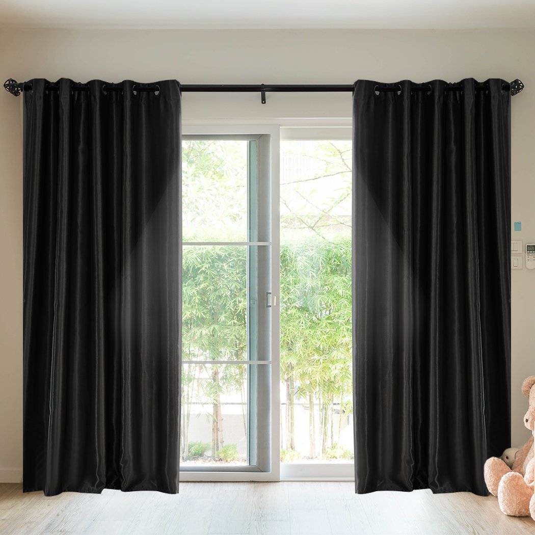 Elegant black 2X blockout curtains with eyelet design, perfect for bedroom windows, providing light blocking and noise reduction.