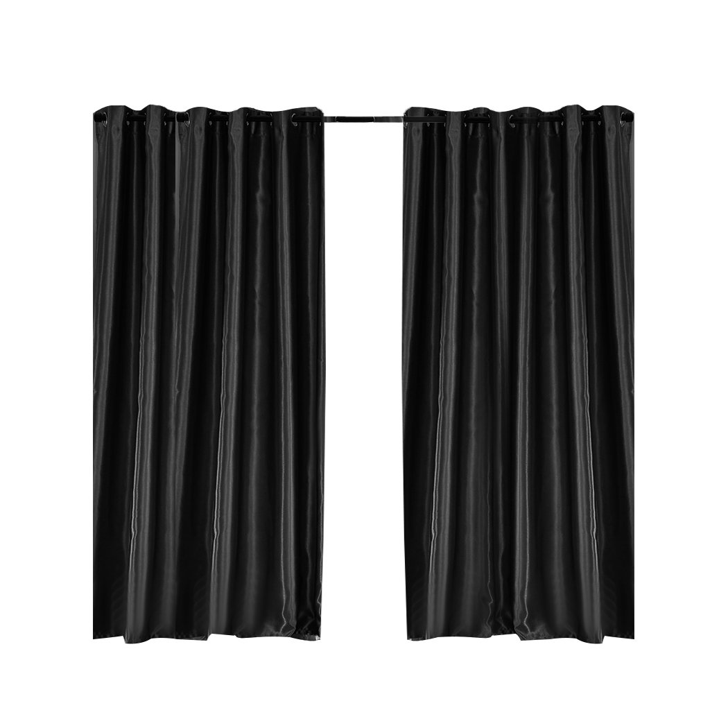 Elegant black 2X blockout curtains with eyelet design, showcasing a luxurious texture and perfect drape, ideal for bedroom windows.