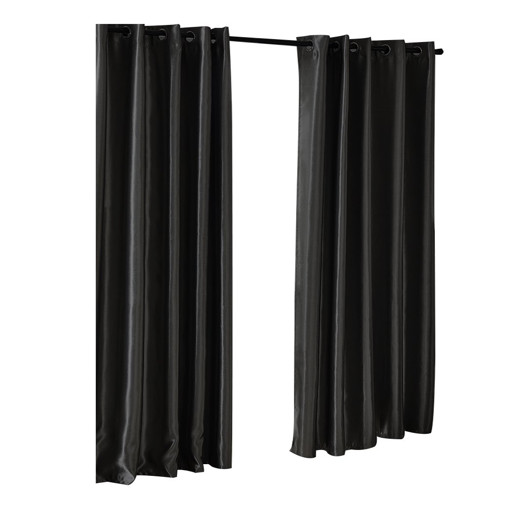 Elegant black 2X blockout curtains with eyelet design, showcasing a luxurious texture and perfect drape, ideal for bedroom windows.