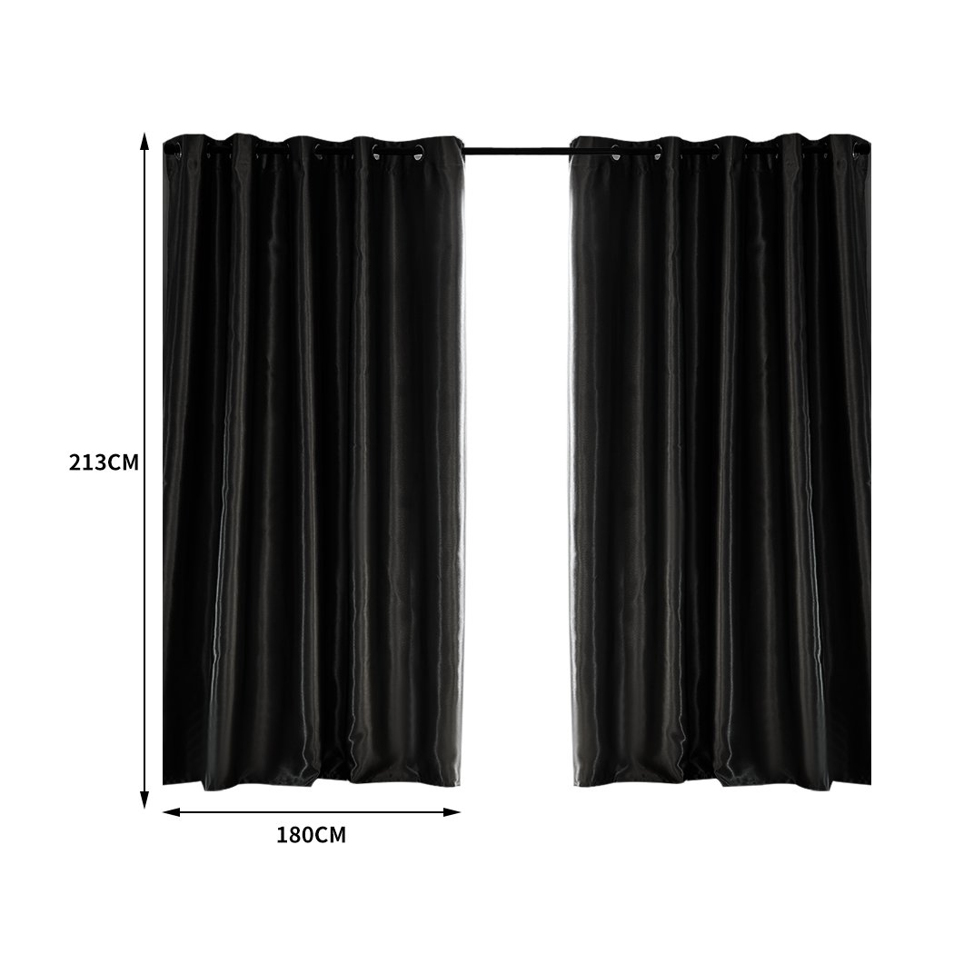 Elegant black 2X blockout curtains with eyelet design, showcasing a luxurious texture and perfect drape, ideal for bedroom windows.