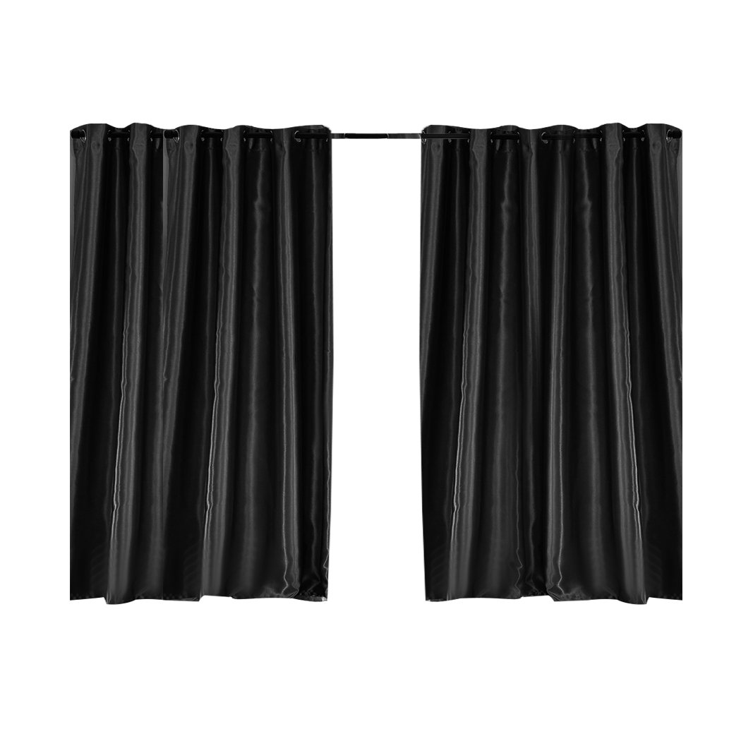 Elegant black 2X blockout curtains with eyelet design, perfect for bedrooms, providing light and noise reduction.