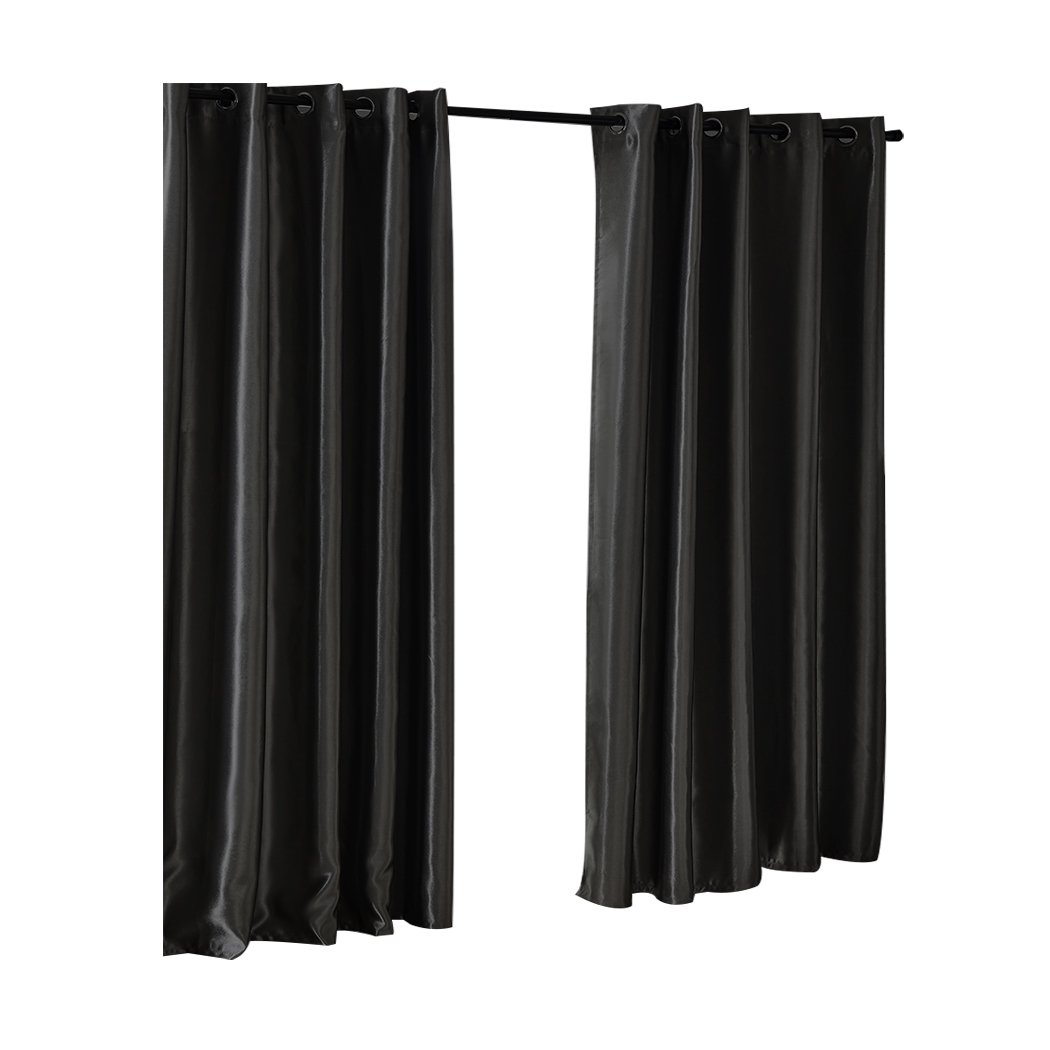 Elegant black 2X blockout curtains with eyelet design, perfect for bedrooms, providing light and noise reduction.